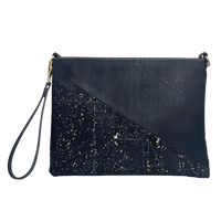 A front view of a black cork purse with a half triangle design. The top triangle is solid black, and the bottom triangle has brilliant gold accents. 