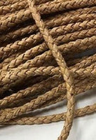 A close up of a braided cork string which is similar to cording without the sewing tab.