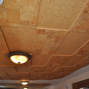 A ceiling where acoutsic tiles have been staggered with tackboard tiles to create a textured look. The warm natural tones make the room feel warm and cozy. 