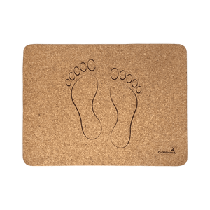 A natural cork bath mat with a set of footprints reminiscent of stepping out of a pool.