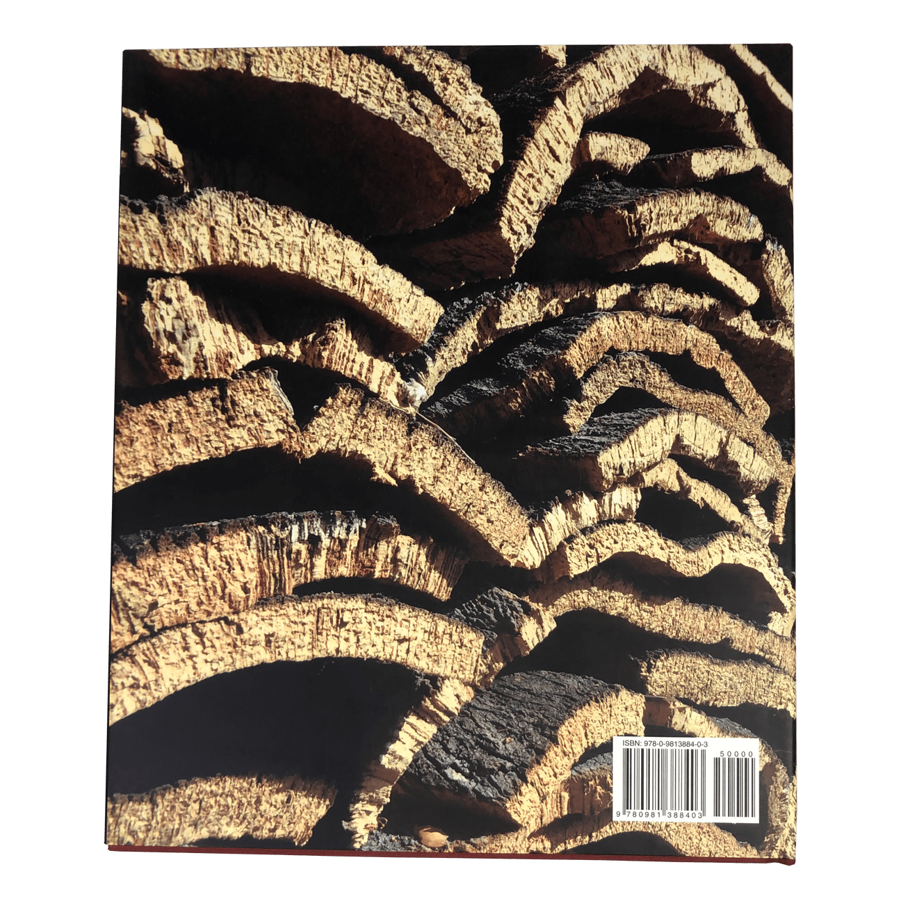 Back cover of the House of Cork book showing cork bark stacked for drying.