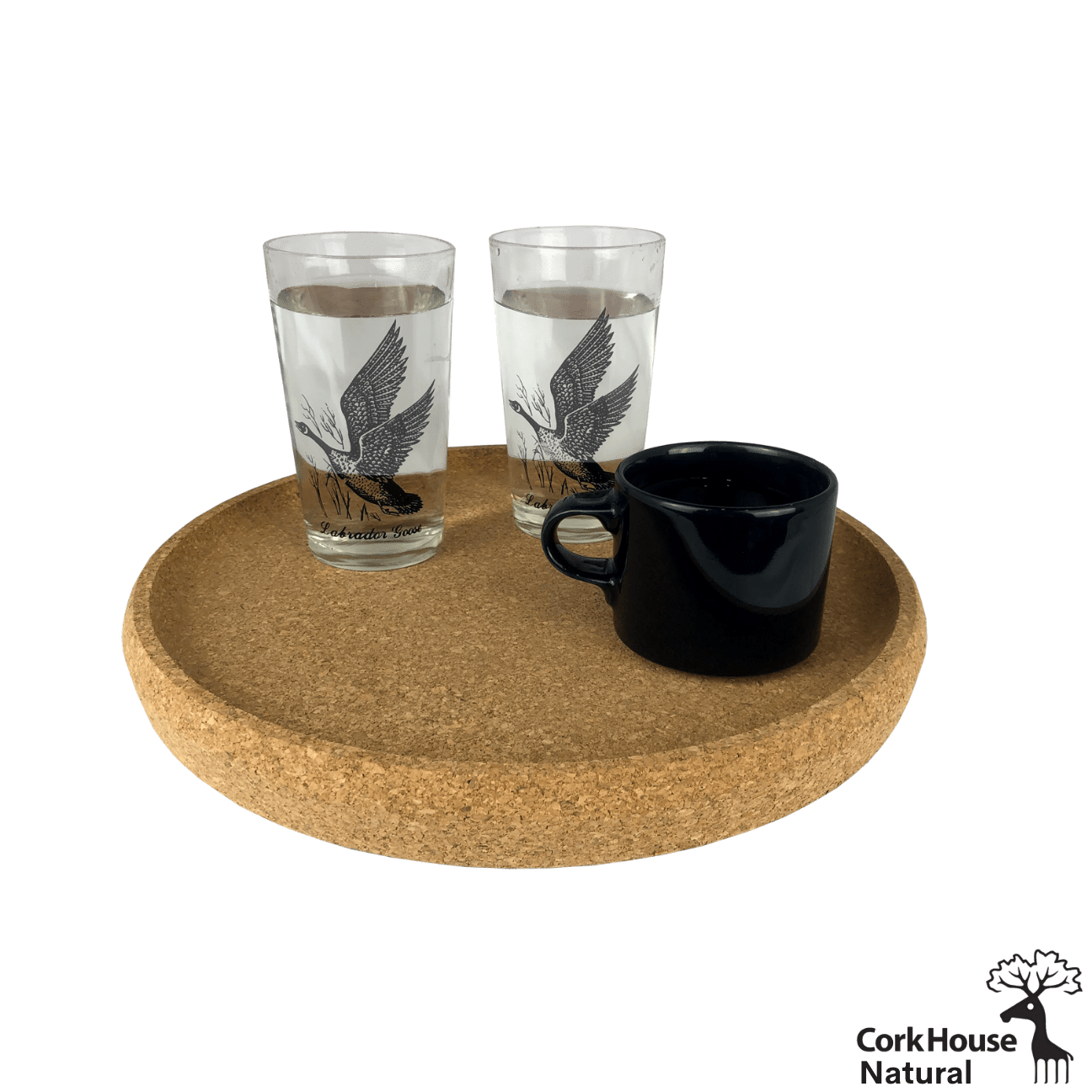 The natural cork tray with raised lip holds two clear glasses of water and a black coffee mug.