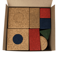 Set of cork building blocks in a box with an assortment of natural, blue , red, and green blocks