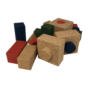 An assortment of natural colored, blue red and green building blocks. 
