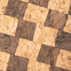 A close up view of the checkered cork fabric where the darker squares are a warm chocolate color and the ligher swuares are a rich natural cork color