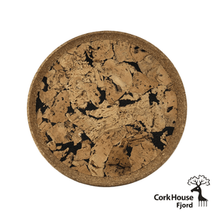 Overhead shot of the cork circular tray with a natural colored cork raised lip and a patterned cork base with black dyed cork contrasting the warm natural cork tones. 