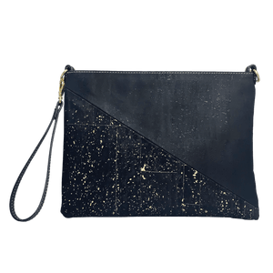 A front view of a black cork purse with a half triangle design. The top triangle is solid black, and the bottom triangle has brilliant gold accents. 