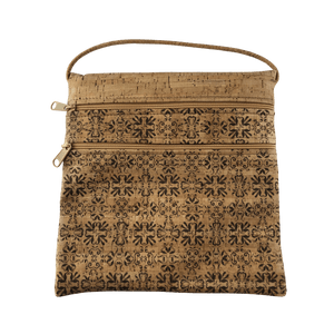 A cork bag with an ink colored traditional pattern on the front below the two zippered pockets.