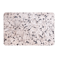 A rectangular marble black cork placemat with rounded corners.