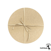 A bundle of two 12-inch circular cork hot pads tied together by raffia.