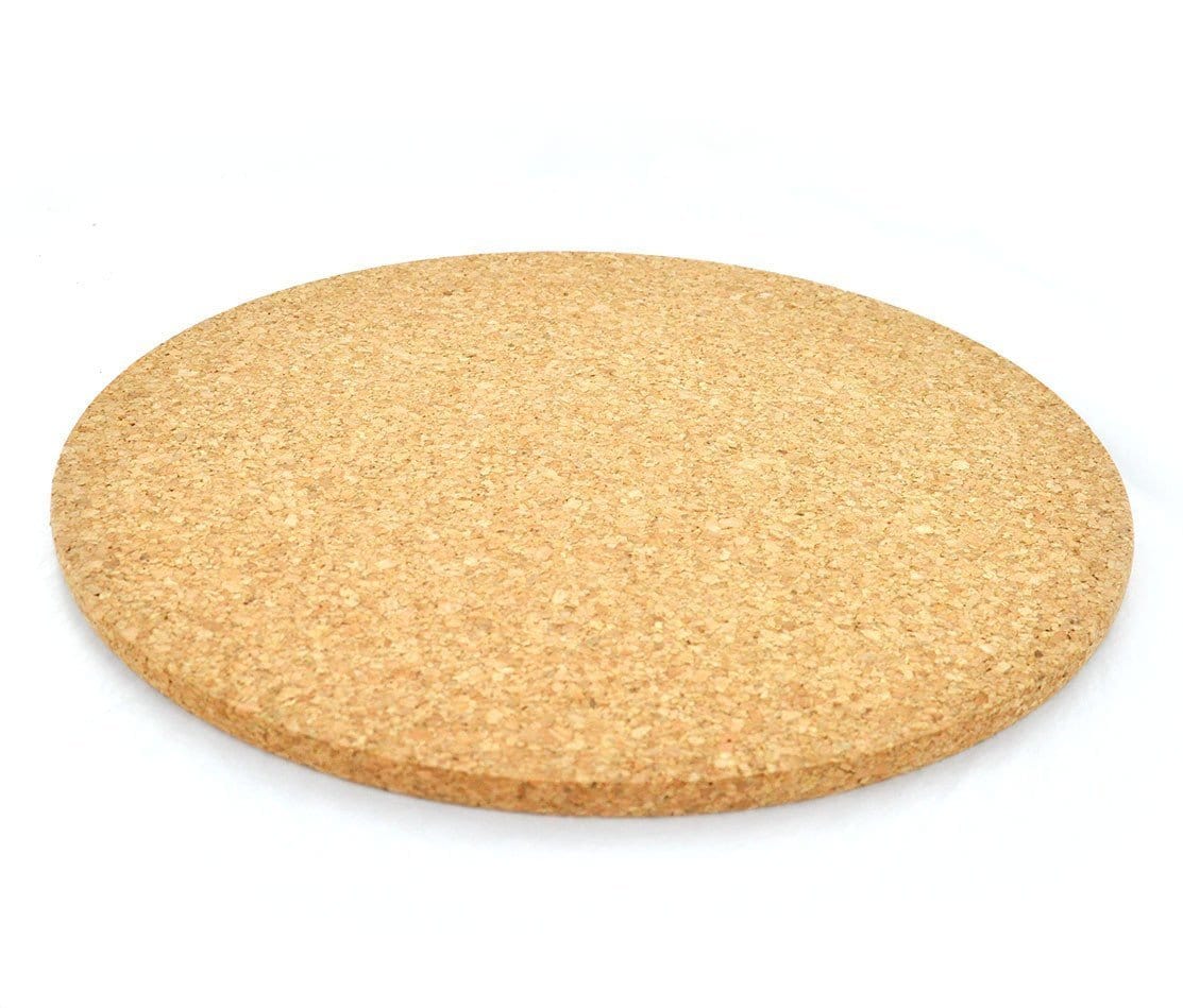 A natural circular cork hot pad with a beveled edge.