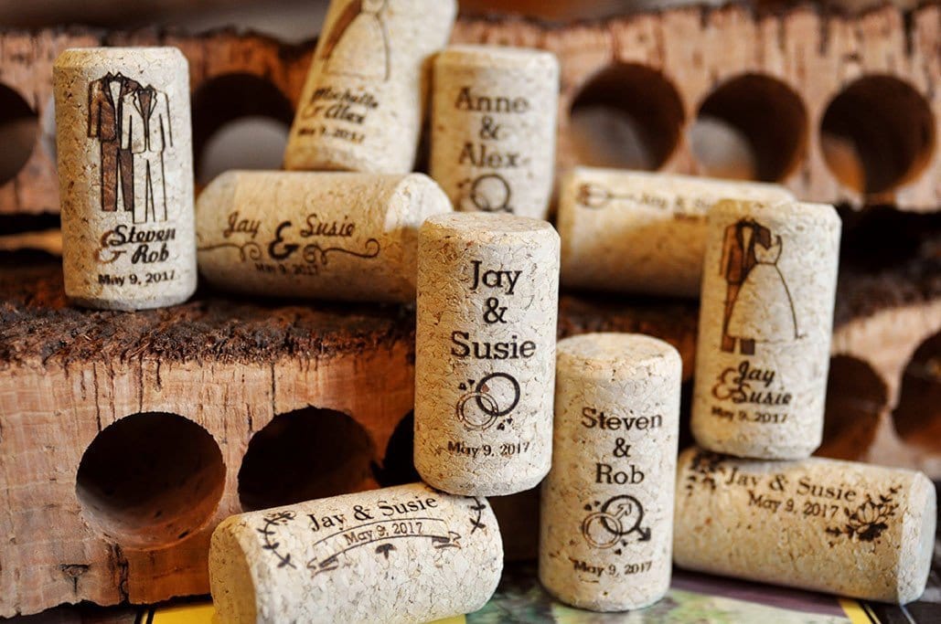 A selection of custom wine corks featuring wedding prints.